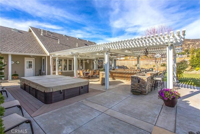 view of patio / terrace with a covered hot tub, a pergola, and outdoor dry bar