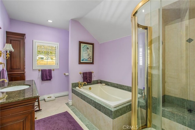 bathroom with vanity, vaulted ceiling, a garden tub, and a stall shower