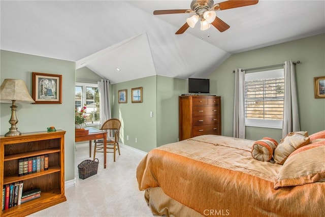 bedroom with light colored carpet, baseboards, vaulted ceiling, and ceiling fan
