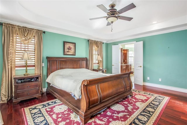 bedroom with ornamental molding, wood finished floors, baseboards, recessed lighting, and connected bathroom
