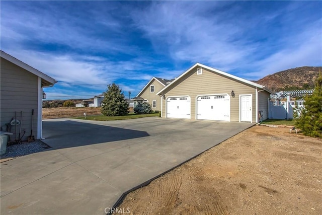 garage featuring a mountain view and concrete driveway