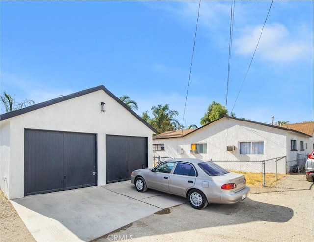 view of property exterior featuring a garage and an outbuilding