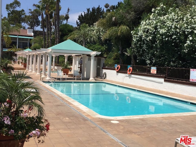 view of swimming pool featuring a patio area and a pergola