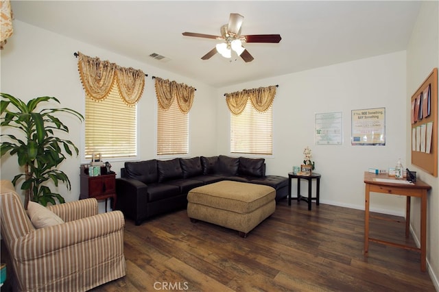 living room with ceiling fan and dark wood-type flooring