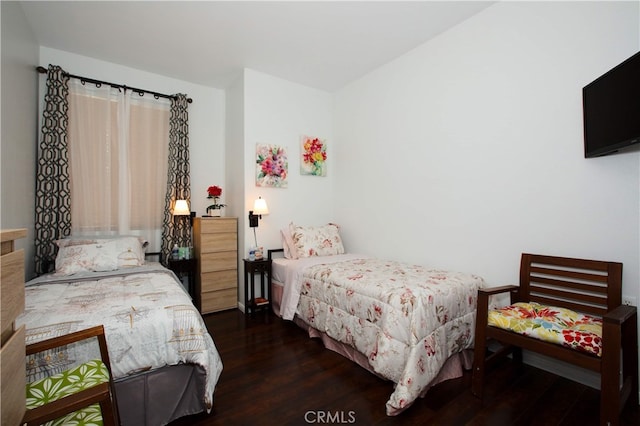 bedroom with dark hardwood / wood-style floors