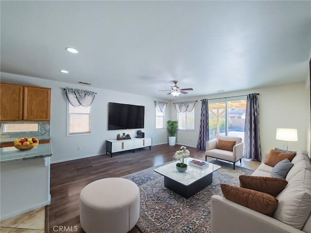 living room with ceiling fan and dark hardwood / wood-style flooring