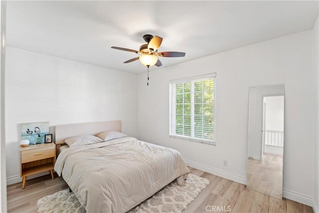 bedroom featuring light wood-type flooring and ceiling fan