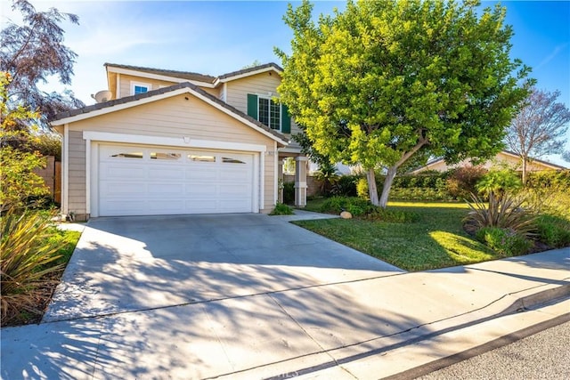 view of front of home featuring a front yard and a garage