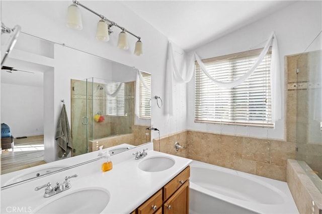 bathroom with vaulted ceiling, shower with separate bathtub, and vanity