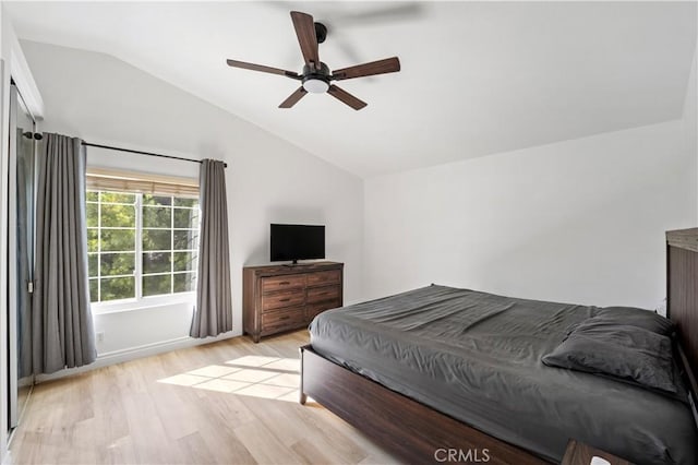 bedroom featuring ceiling fan, lofted ceiling, and light wood-type flooring