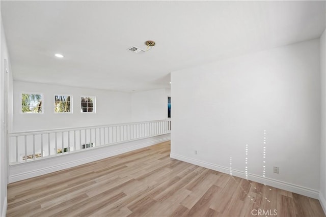 spare room featuring light hardwood / wood-style flooring