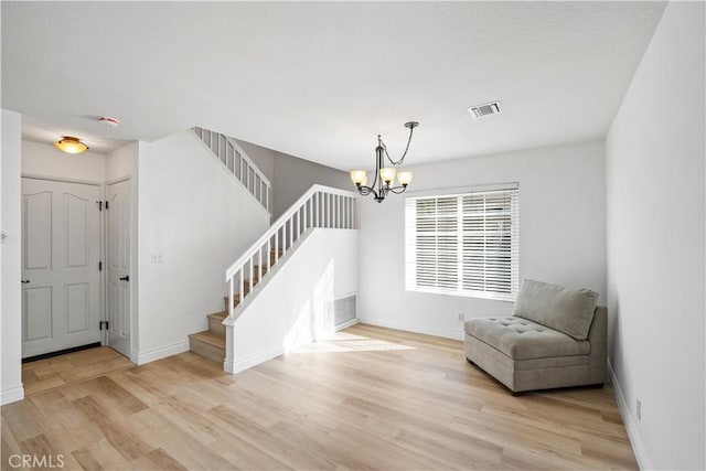 sitting room featuring light hardwood / wood-style flooring and a chandelier