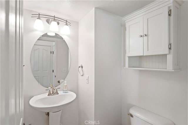 bathroom featuring toilet and sink