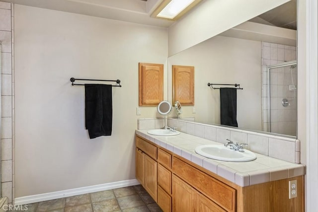 bathroom with vanity and a shower with shower door