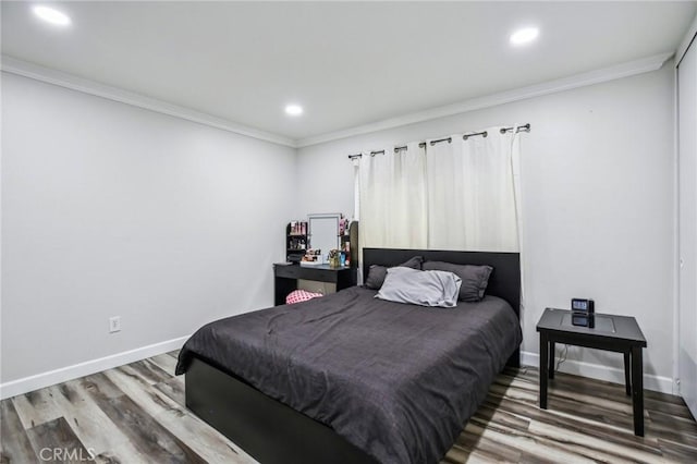 bedroom with crown molding and hardwood / wood-style floors