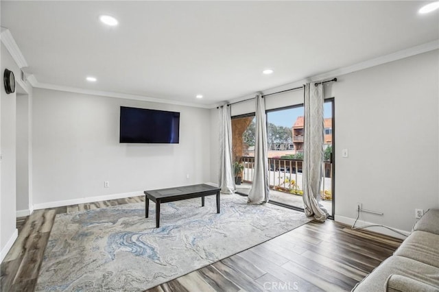 living room with hardwood / wood-style floors and crown molding