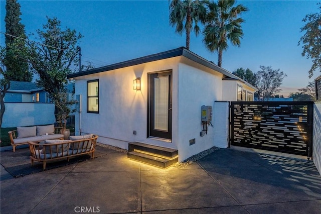 view of front of home with an outdoor living space and a patio