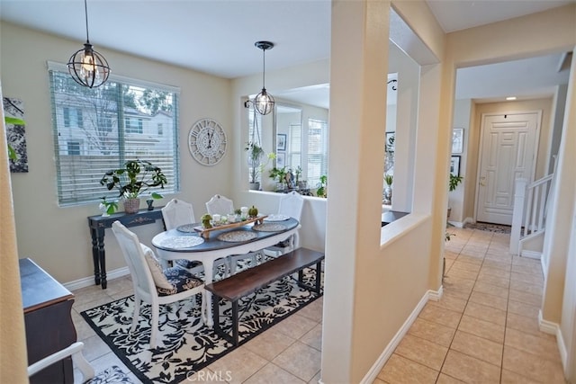 dining area featuring light tile patterned floors and a chandelier