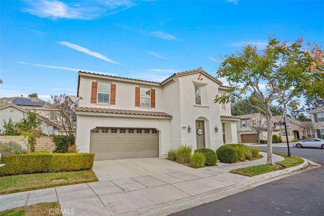 mediterranean / spanish-style home with a garage