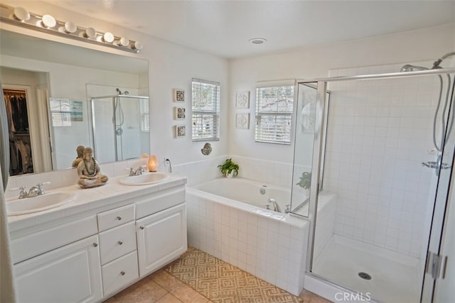 bathroom with independent shower and bath, tile patterned floors, and vanity