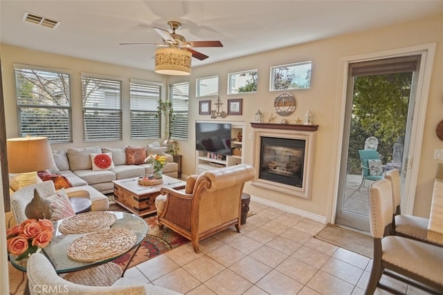 tiled living room featuring ceiling fan