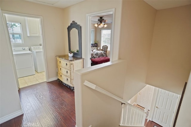 corridor with washer and dryer and dark hardwood / wood-style flooring