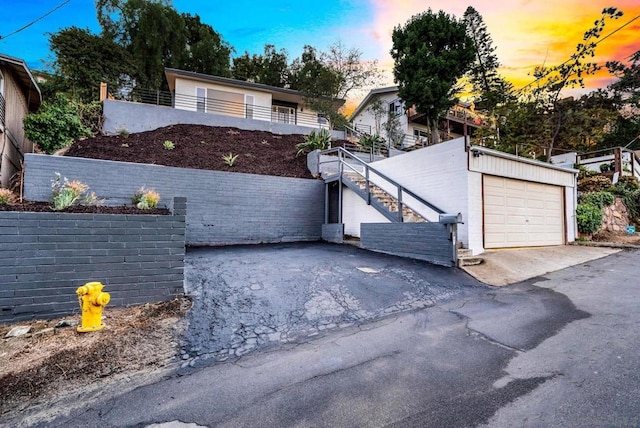 view of front of property featuring a garage and an outdoor structure