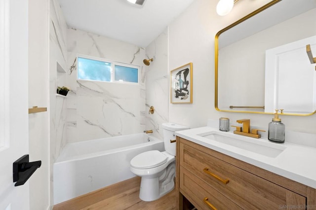 full bathroom with hardwood / wood-style flooring, toilet, vanity, and tiled shower / bath