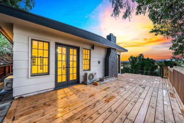 deck at dusk featuring french doors and ac unit