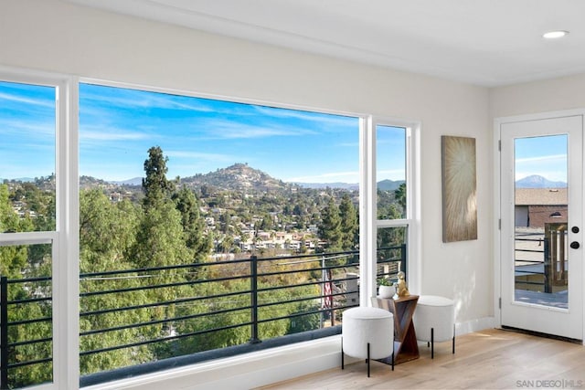 sunroom with a mountain view and a wealth of natural light