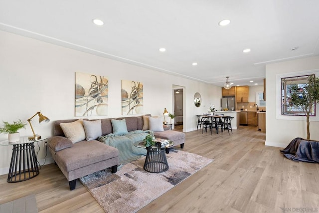 living room featuring light wood-type flooring and sink