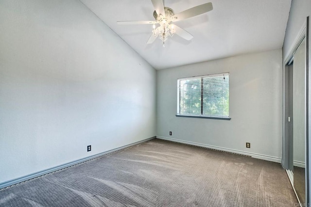 unfurnished bedroom with ceiling fan, carpet, and lofted ceiling