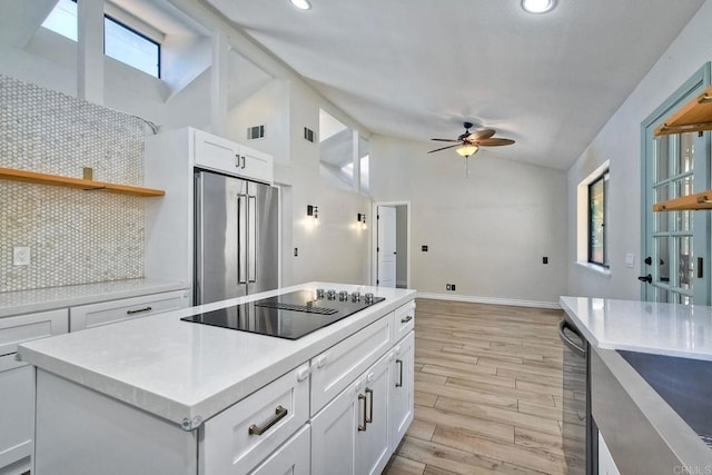 kitchen with ceiling fan, stainless steel appliances, decorative backsplash, and white cabinetry