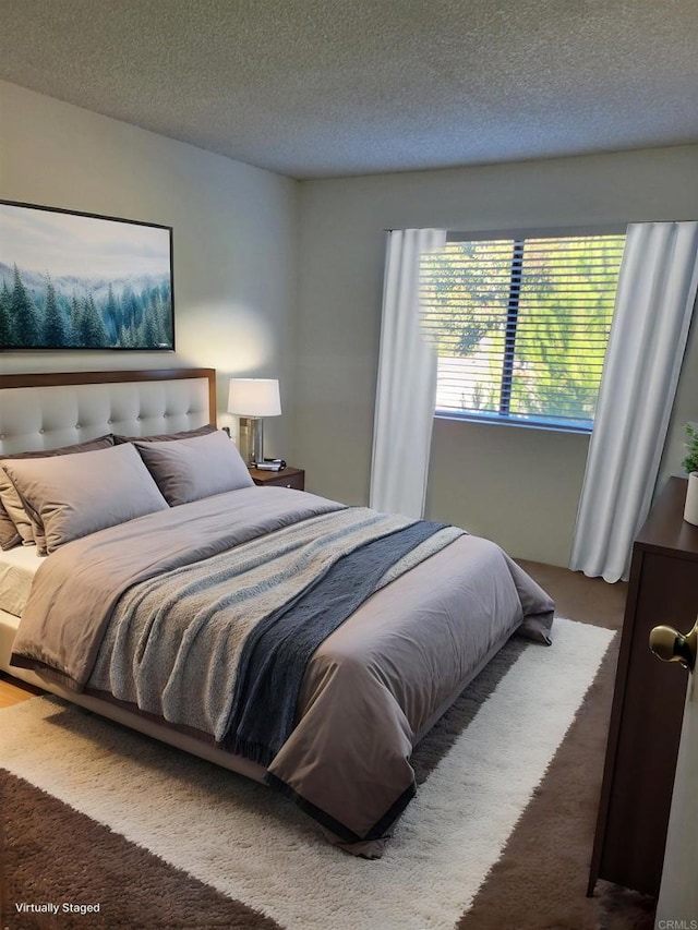 carpeted bedroom with a textured ceiling