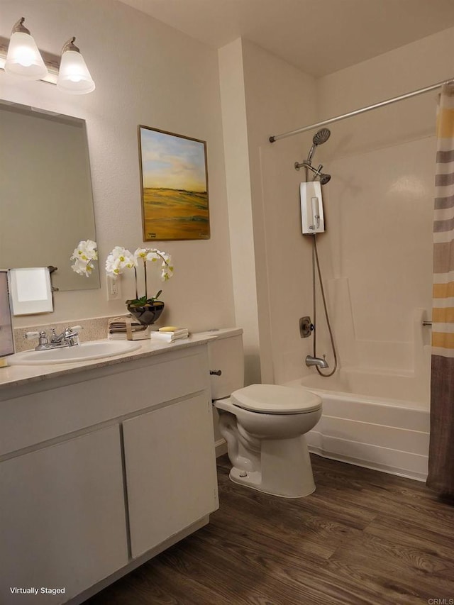 bathroom with shower / tub combo with curtain, vanity, toilet, and wood finished floors