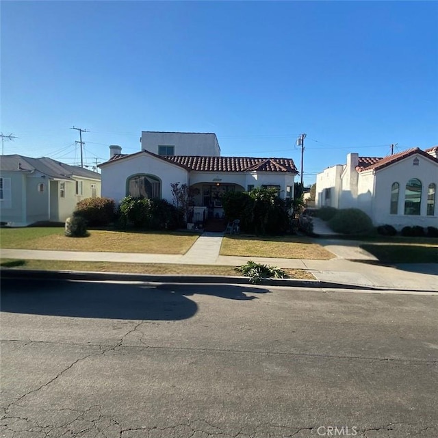 mediterranean / spanish-style house featuring a front lawn