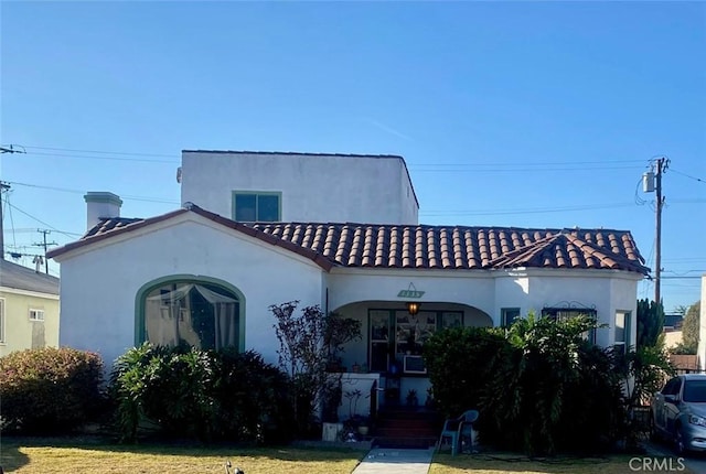 mediterranean / spanish-style house featuring a front lawn