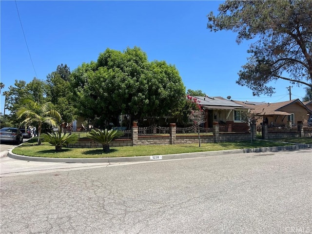 view of front of property featuring solar panels