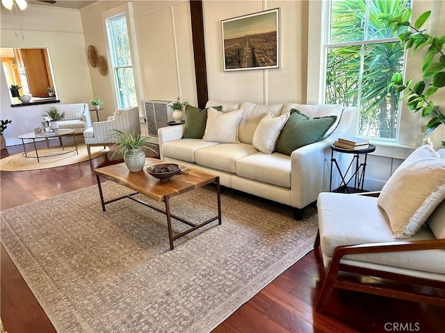 living room featuring ceiling fan and dark wood-type flooring