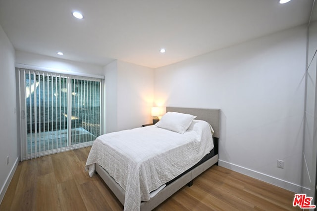 bedroom with hardwood / wood-style floors