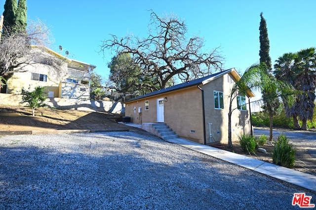 view of side of home featuring central AC