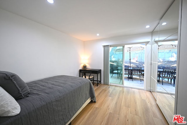 bedroom featuring light wood-type flooring and access to exterior