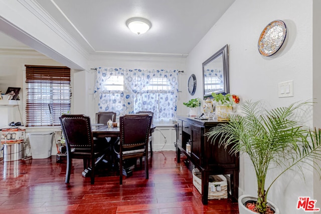 dining room with dark wood-type flooring and ornamental molding