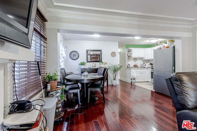 dining room with ornamental molding and hardwood / wood-style floors