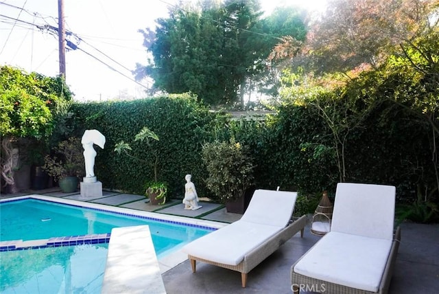 view of pool featuring a pool with connected hot tub and a patio