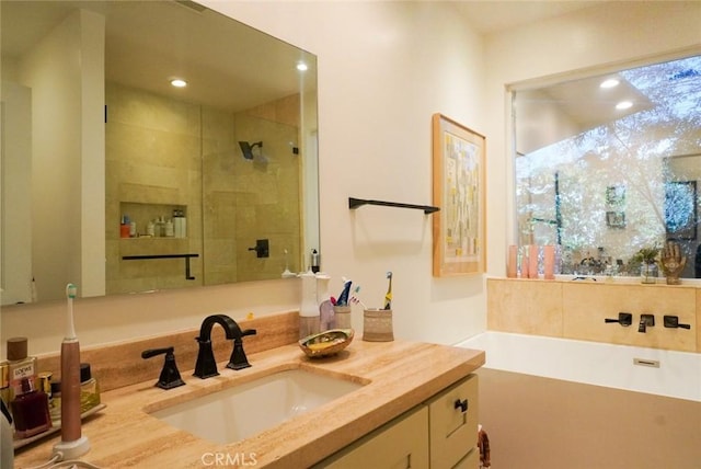 full bath featuring a bathtub, a stall shower, vanity, and recessed lighting