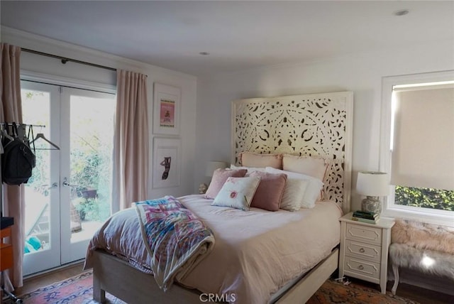 bedroom featuring access to outside, dark wood-style flooring, and french doors