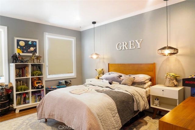 bedroom featuring crown molding and wood finished floors