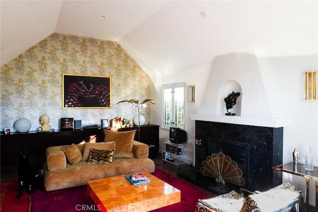 living room with lofted ceiling and a premium fireplace