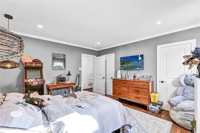 bedroom featuring recessed lighting, crown molding, and wood finished floors